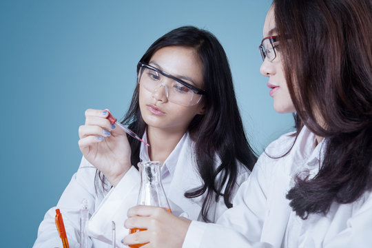 Two young scientists doing chemical research