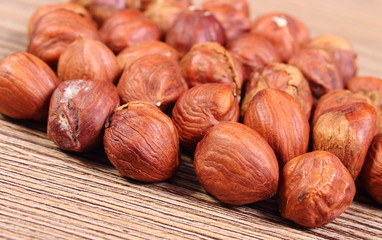Heap of brown hazelnut on wooden table