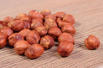 Heap of brown hazelnut on wooden table