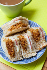 Freshly made shredded pork sandwich served on plate.