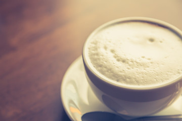 Hot latte art coffee on table ( Filtered image processed vintage