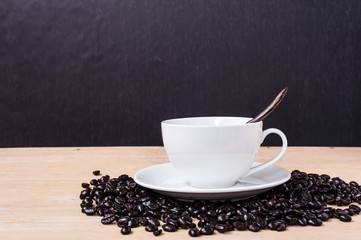 Fresh coffee with a cup of coffee on wooden