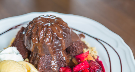 Chocolate cake with fruit peach, black currant, blueberry, apple