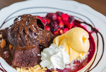 Chocolate cake with fruit peach, black currant, blueberry, apple