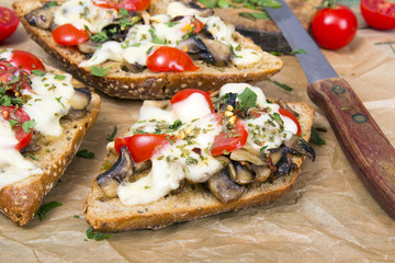 delicious bruschetta with tomatoes, cheese and mushrooms