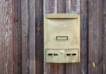 mailbox on a wooden fence