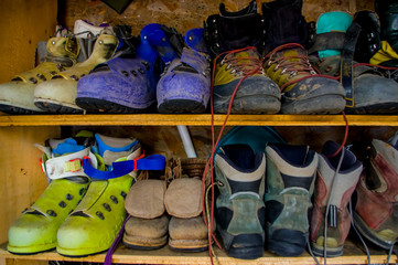 climbing boots in an outdoor shoe shelf
