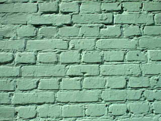 Fragment of a green brick wall
