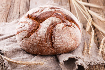 Round Loaf of Home made Bread made from rye, whole wheat flour and sourdough in rustic style, selective focus