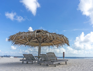 Dreamy beach with sun loungers under a beach umbrella at Mabul, Semporna Sabah.