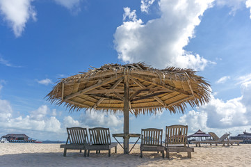 Dreamy beach with sun loungers under a beach umbrella at Mabul, Semporna Sabah.