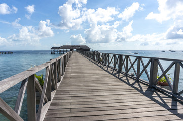 Wooden jetty with blue skies