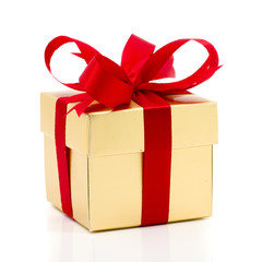 Beautiful gold present box with red bow and ribbons