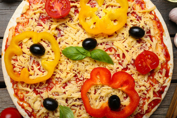 Raw pizza with vegetables close up