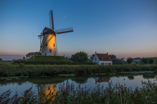Sunrise over windmill in Damme, Belgium