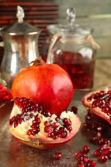 Pomegranate seeds and juice on table, closeup