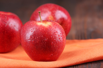 Ripe red apples on table close up