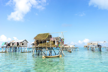 SABAH, MALAYSIA - AUGUST 17, 2015 : Bajau Laut house in Bodgaya Island, Sabah, Malaysia. They lived in a house built on stilts in the middle of sea, boat is the main transportation here.