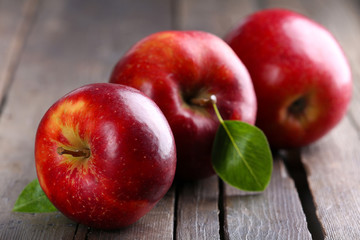 Ripe red apples on table close up