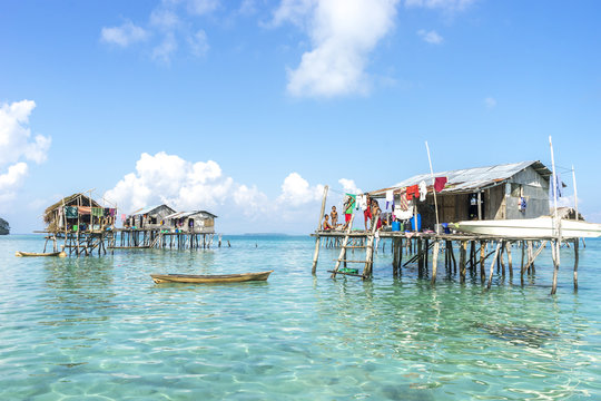 SABAH, MALAYSIA - AUGUST 17, 2015 : Bajau Laut house in Bodgaya Island, Sabah, Malaysia. They lived in a house built on stilts in the middle of sea, boat is the main transportation here.