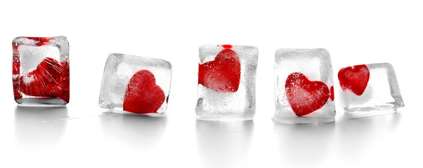 Red hearts in ice cubes isolated on white