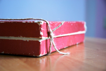 old paper box tied with a rope on the wooden table