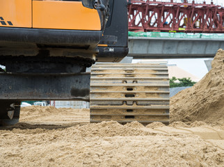 Wheel loader Excavator with backhoe unloading sand at eath works
