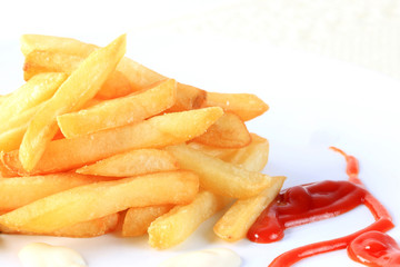 French fries with tomato sauce and mayonnaise on white backgroun