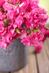 Beautiful bouquet of pink carnation in watering can close up