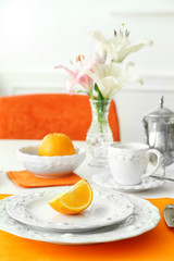Table setting with orange napkin