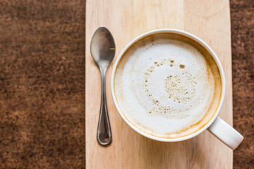 hot latte art coffee  on wooden table, vintage and retro style.
