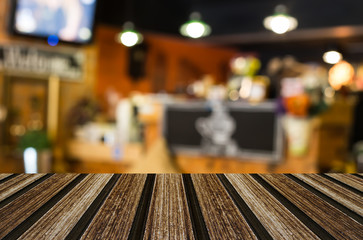 Selected focus empty brown wooden table and Coffee shop blur bac