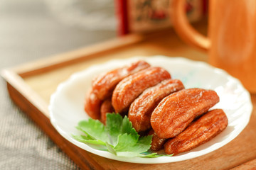 Sun dried bananas bake with honey on wood background.
