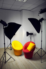 Photo studio with modern interior and lighting equipment
