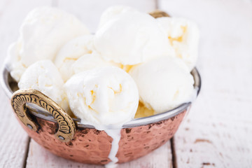Cream white, ice cream balls in a metal authentic bowl.selective focus