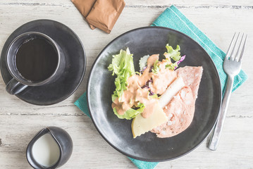 Top of view brakfast dish on wood table - light vintage filter e