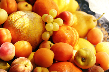 Naklejka na ściany i meble Heap of fresh fruits on tray close up