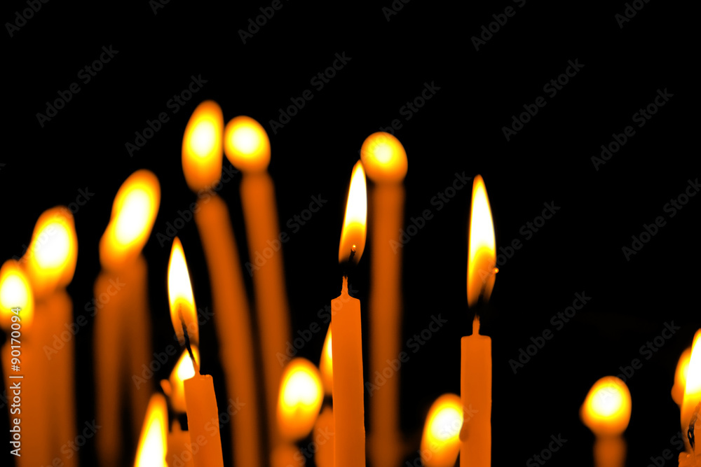 Wall mural Burning church candles in dark