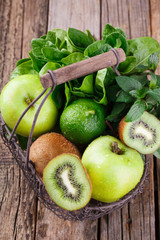 Basket of green fruit. Vitamin green set of kiwi,Apple, spinach, mint,lime.Smoothie with spinach and kiwi.selective focus