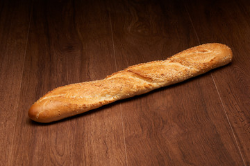 French baguette bread on dark wooden table background