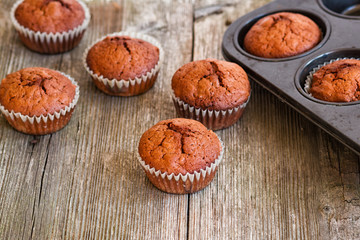 delicious homemade muffins over wooden board selective focus