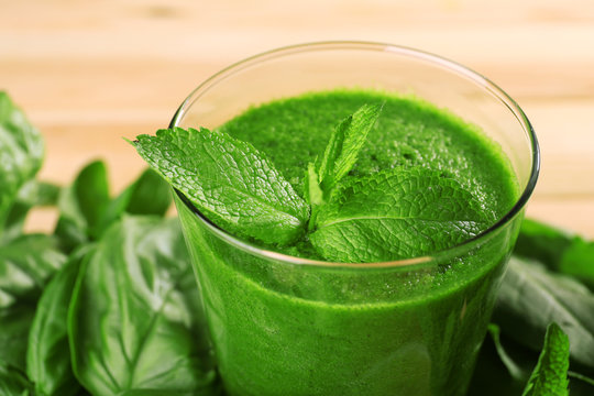 Green healthy juice with herbs close up