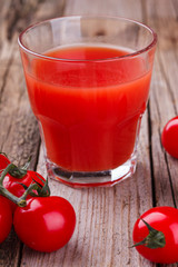 Tomato juice in a glass beaker. Vine tomatoes and Basil.selective focus
