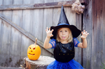a little girl dressed as a witch for Halloween