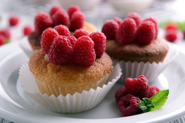 Delicious cupcakes with berries and fresh mint on wooden table close up