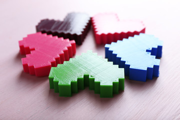 Plastic hearts on wooden background