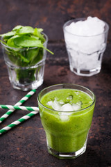 Green smoothie with spinach and kiwi, vitamin cocktail with ice.
