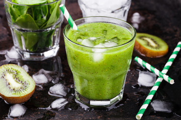 Green smoothie with spinach and kiwi, vitamin cocktail with ice.