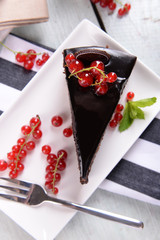 Naklejka na ściany i meble Tasty chocolate cake with berries on table close up