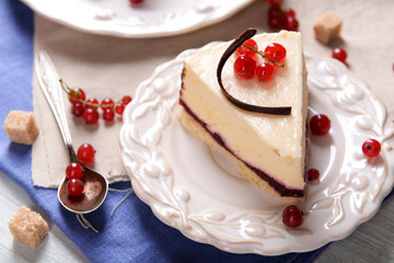 Tasty cheesecake with berries on table close up